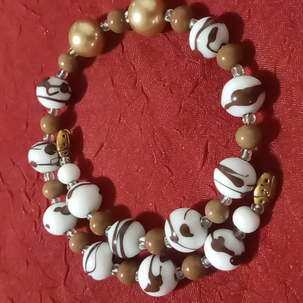 Glass beaded white & brown swirls memory wire wrap bracelet.with lady bug